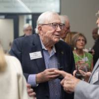 President Emeritus Don Lubbers speaking with gentleman at event